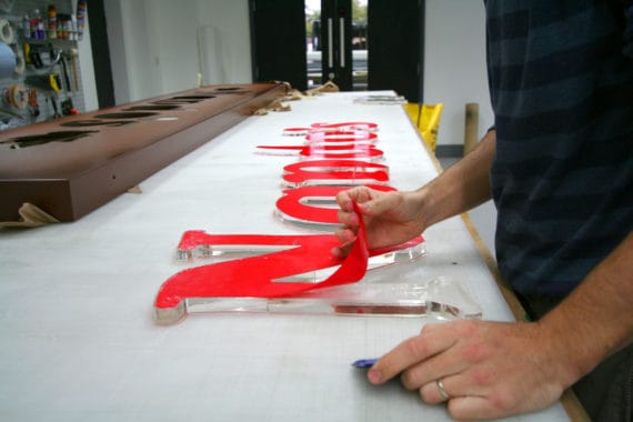 Application of vinyl graphics to a Nando's restaurant sign