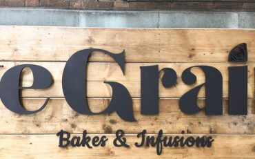 Cafe Sign in close up. Warm wood. Warm Welcome