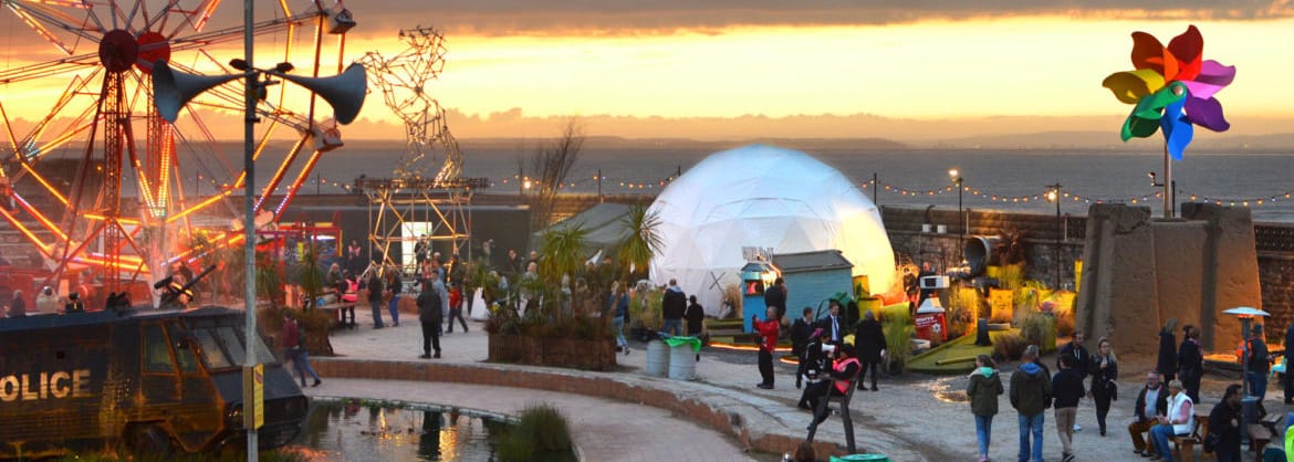 Dismaland at dusk showing the scale of the Windmill created for Banksy by Voodoo DesignWorks