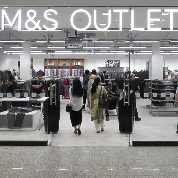 Internally LED illuminated built up letters reading M&S on the Lowry Outlet store front
