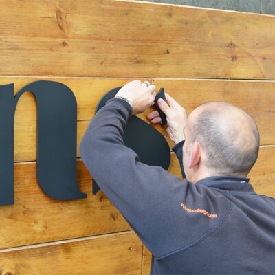 Installation of an external sign using acrylic letters onto a wooden fascia