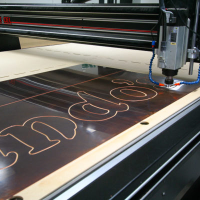 A restaurant sign being machined on the bed a CNC router