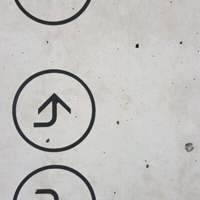 Wayfinding and Directional Signs applied directly to concrete