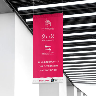 A banner at a shopping centre with with Social Distancing Graphics