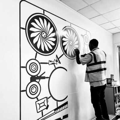 Large format custom stickers being applied to a wall