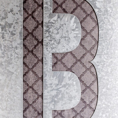 Corian letter with etched metal inlay