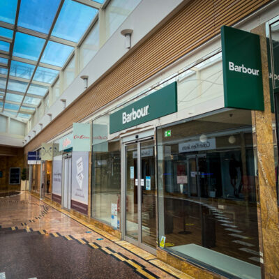 Wide angle shot of main fascia sign for Barbour retail unit at Gloucester Quays