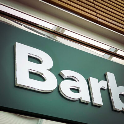 Close up of main fascia sign for Barbour retail unit at Gloucester Quays